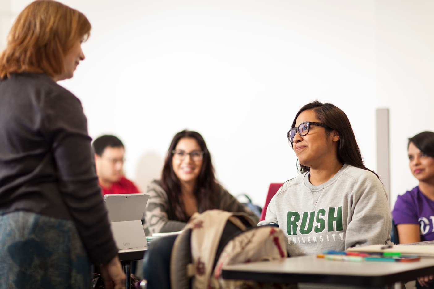 Student sits in class wearing a Rush shirt.