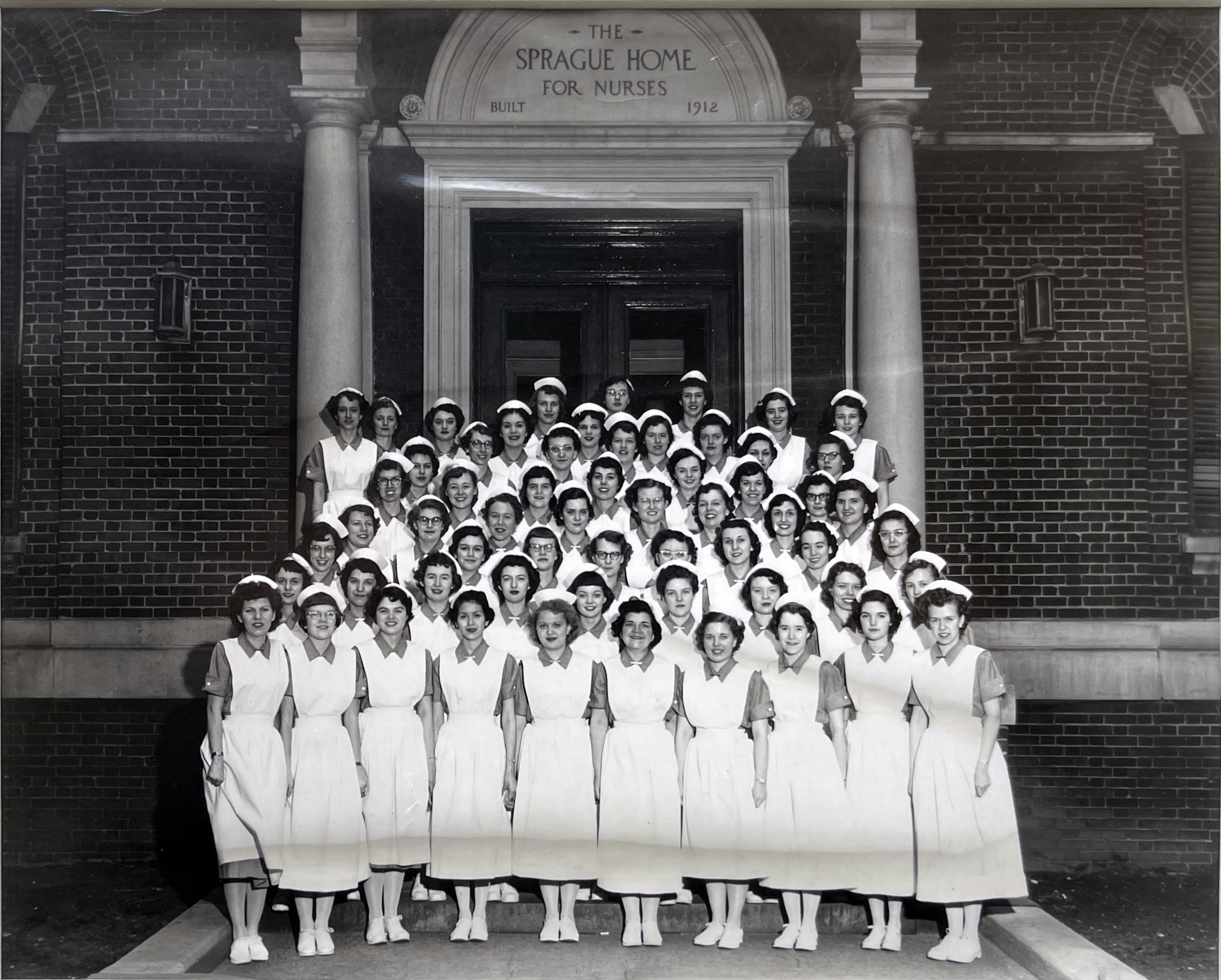 Black and white photo of a posed group of nursing students