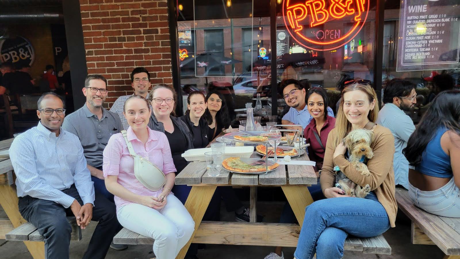 Fellowship classes of 2025 and 2026 gather to enjoy some pizza and happy hour at PB&J.