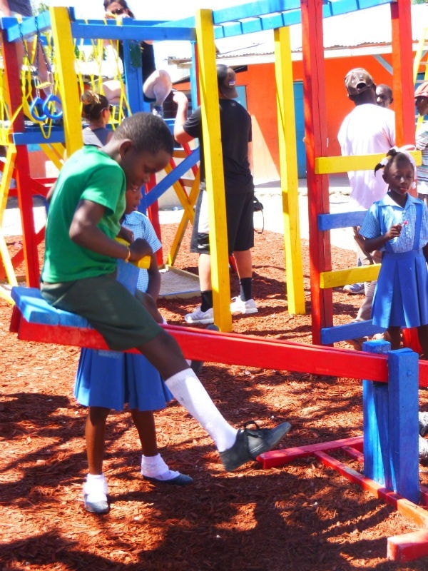 Children playing on brightly colored playground equipment