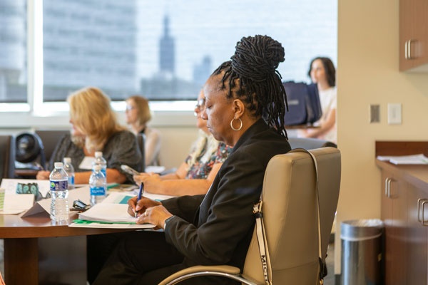 Woman at a table attending conference