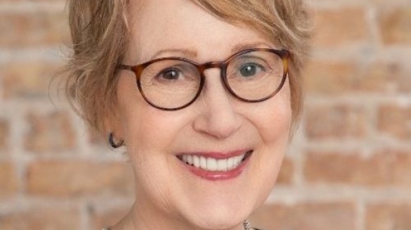 Image of Janet Shlaes, smiling woman with white hair and glasses.