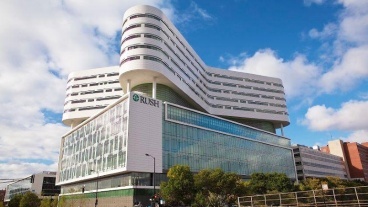 Exterior view of the Rush Tower building with blue sky visible behind